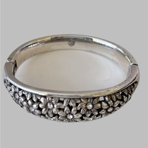 Brighton hinged bangle bracelet with a floral, likely daisy, design.